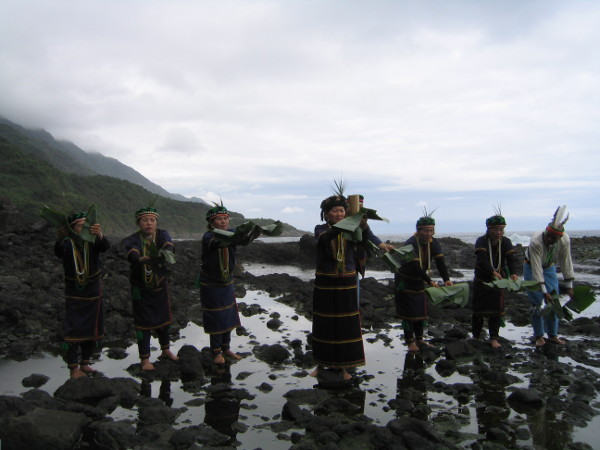 Performance group rehearse by the sea.