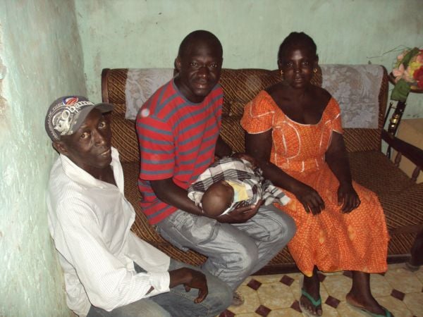 4u: Moses is in the home of our night watchman with their new baby 'Heather' in 2012 after the naming ceremony held at their home. We are the 'godparents' of the baby and will be sponsoring her through school when she is old enough.