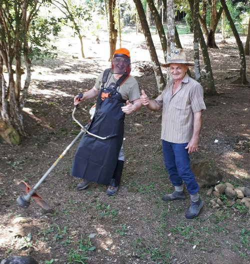 2.7 - The picture shows Jeff receiving a lesson on land management from local Sr Joao.  Sr Joao used to help with the ground care at the Pousada before he retired.