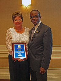 Hugh Riley, secretary general of the Caribbean Tourism Organization, presents the award to Storm. (Credit – Kate Pocock).