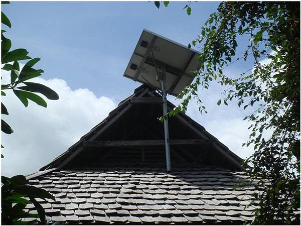 2b - Solar panel on top of a bungalow’s wooden shingled roof